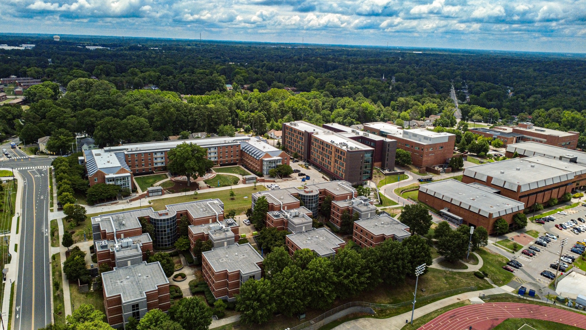 Wide aerial photograph of campus buildings and the surrounding landscape