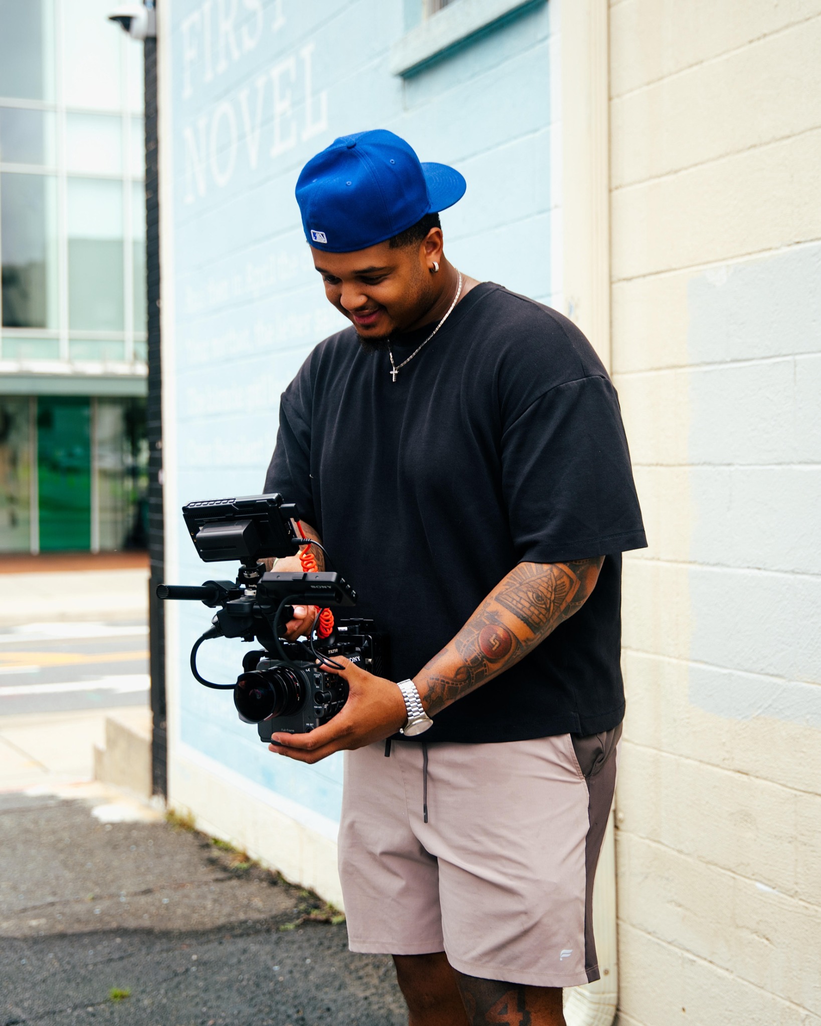 L.J. Jefferson III holding a professional video camera outdoors